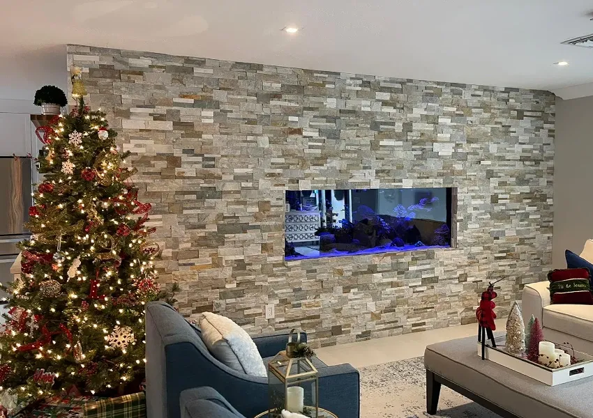 In-wall aquarium integrated into a stone textured wall