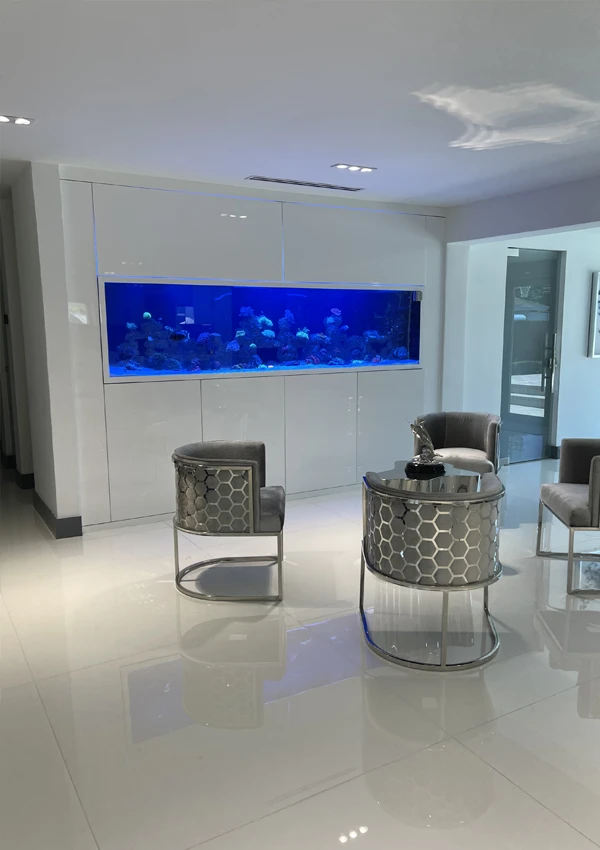 Built-in aquarium connecting a hotel lounge with a recreation area.