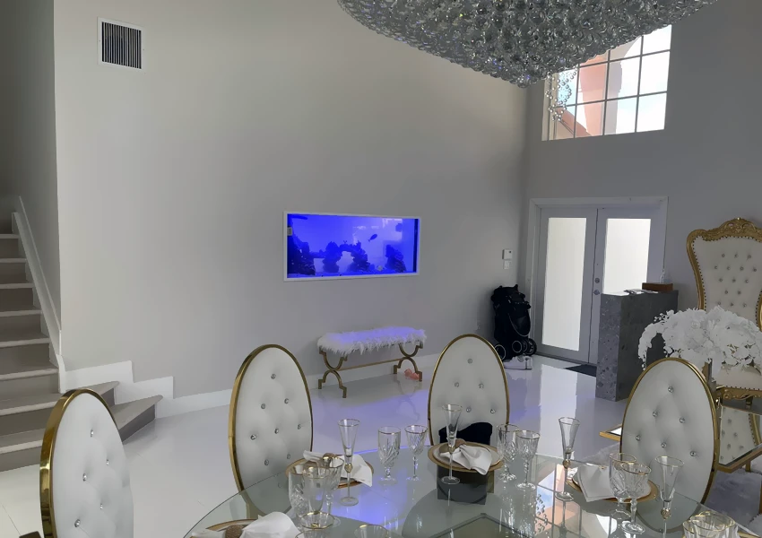 Built-in aquarium placed inside a dining room wall
