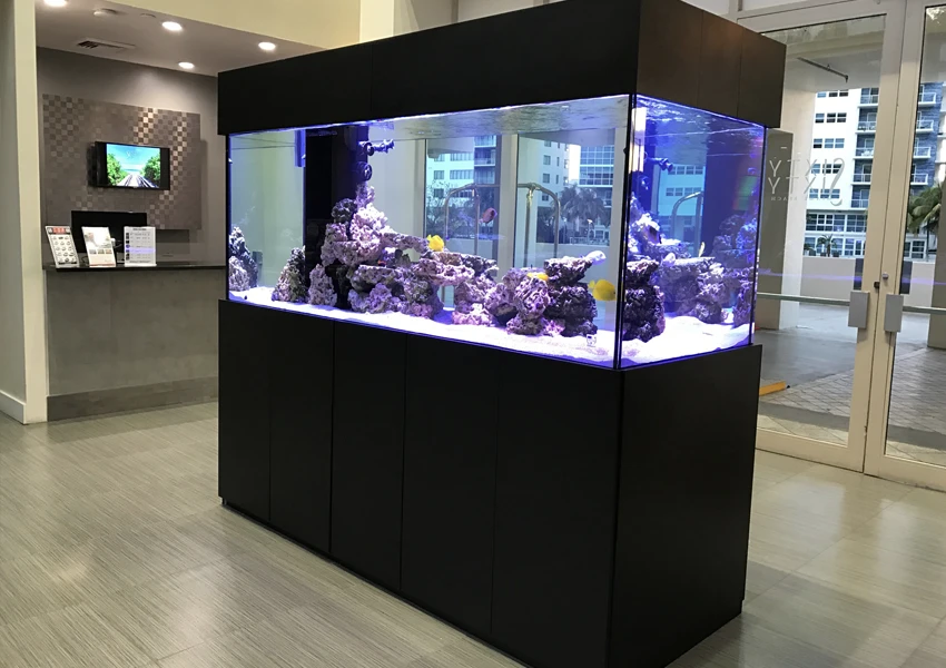 Freestanding island-style aquarium in the center of a hotel lobby.