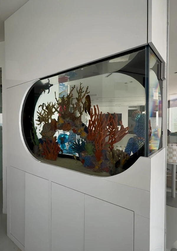 Custom peninsula aquarium designed for seahorses in a high-end living room